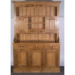 Pine dresser, with a moulded cornice, pierced frieze, panelled back, fitted with cupboards,