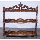 Victorian walnut three-tier graduated and wall-mounted shelf unit, fretted ends,