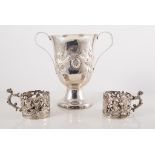 Silver twin handled chalice and pair of silver cup holders,