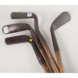 Four vintage hickory shafted golf clubs - an antique hand forged putter with square head and