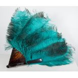 A turquoise ostrich feather fan with simulated tortoiseshell sticks mounted with the name "Florrie",