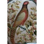 Large decorative red velvet cushion with oval panel of machine wool work bird sitting on a
