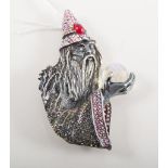 A Butler & Wilson Wizard brooch, the wizard holding a faceted crystal sphere in his hand,