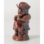 Staffordshire treacle glazed Toby Jug, 'Taking Snuff' with hat, 19th century, 25cm.