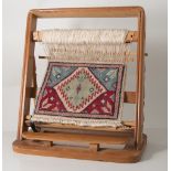 Miniature carpet on loom plus Jones file of fabric samples.