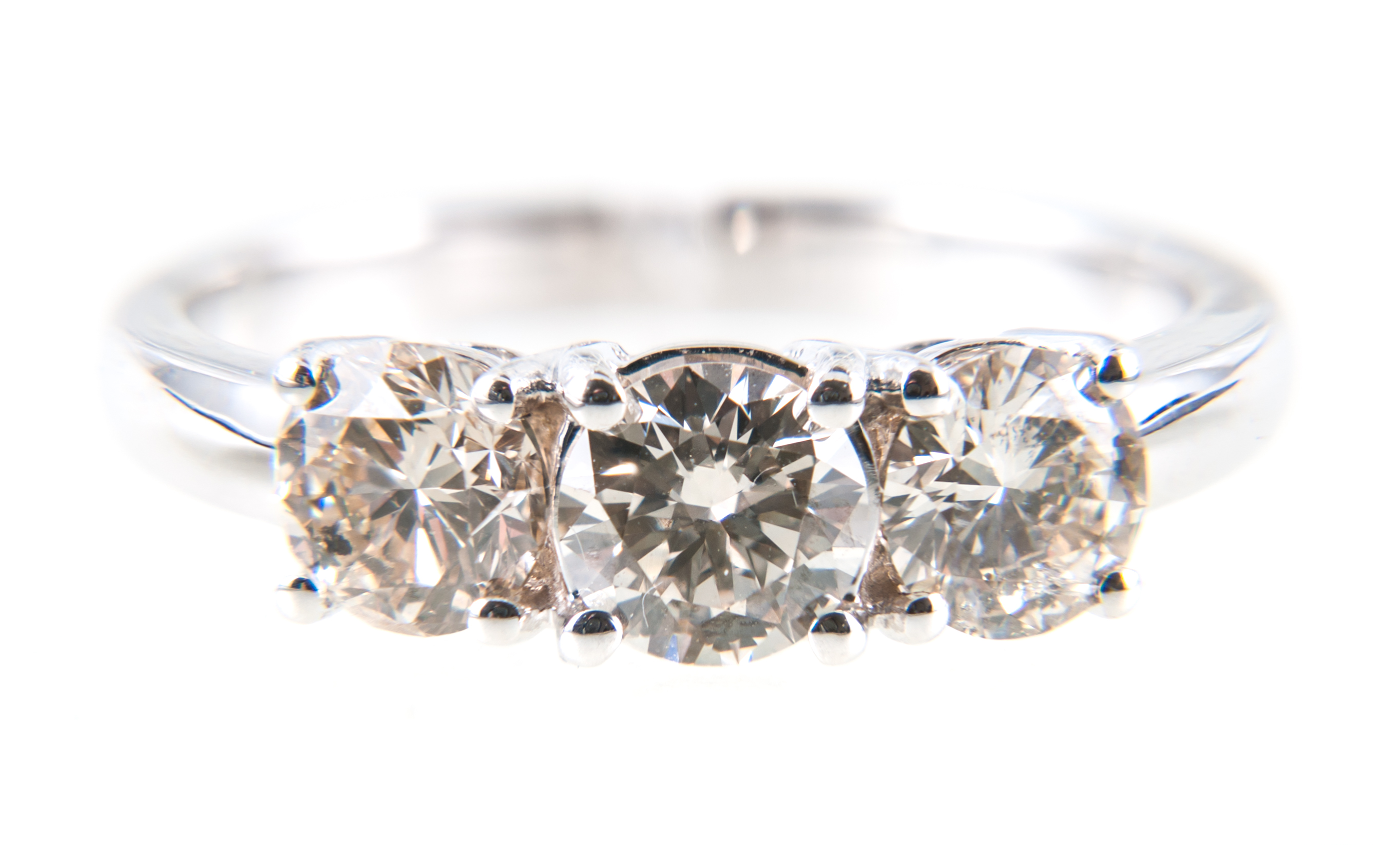 A diamond three stone ring, the brilliant cut stones, slightly graduating in size,