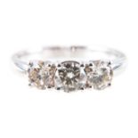 A diamond three stone ring, the brilliant cut stones, slightly graduating in size,