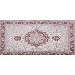 Tabriz pattern rug, central medallion on an ivory coloured ground, with stylised floral motifs,