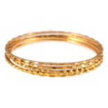 Five 22 carat yellow gold slave bangles, 2mm wide brightly cut design, internal diameter 60mm,