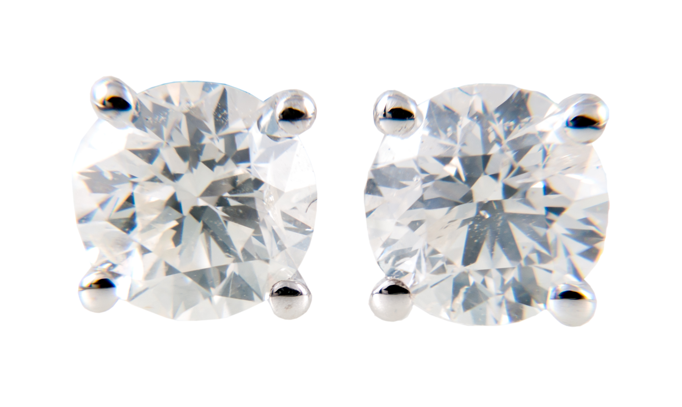 A pair of diamond single stone earrings,