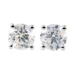 A pair of diamond single stone earrings,