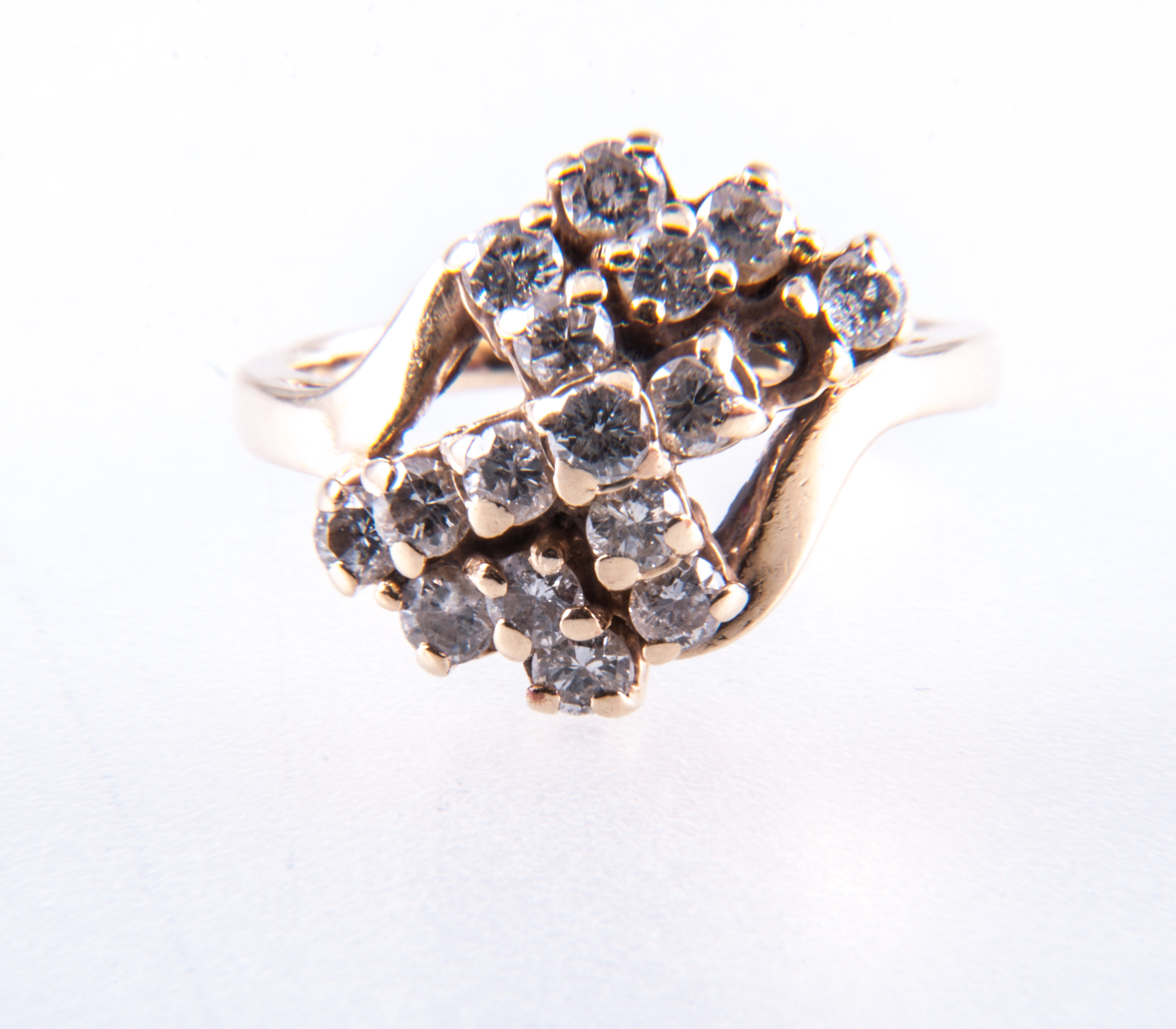 A diamond cluster ring, sixteen brilliant cut diamonds, (one missing),