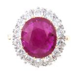 A ruby and diamond oval cluster ring, the oval faceted ruby 13mm x 11mm,