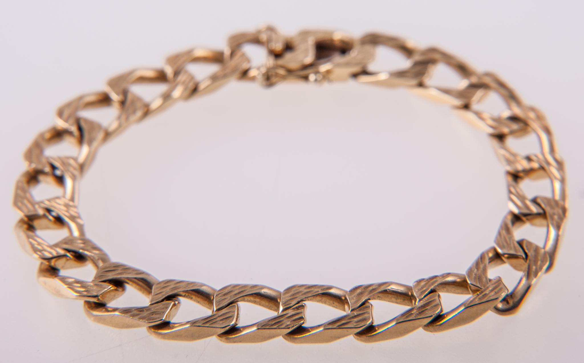 A yellow metal bracelet,