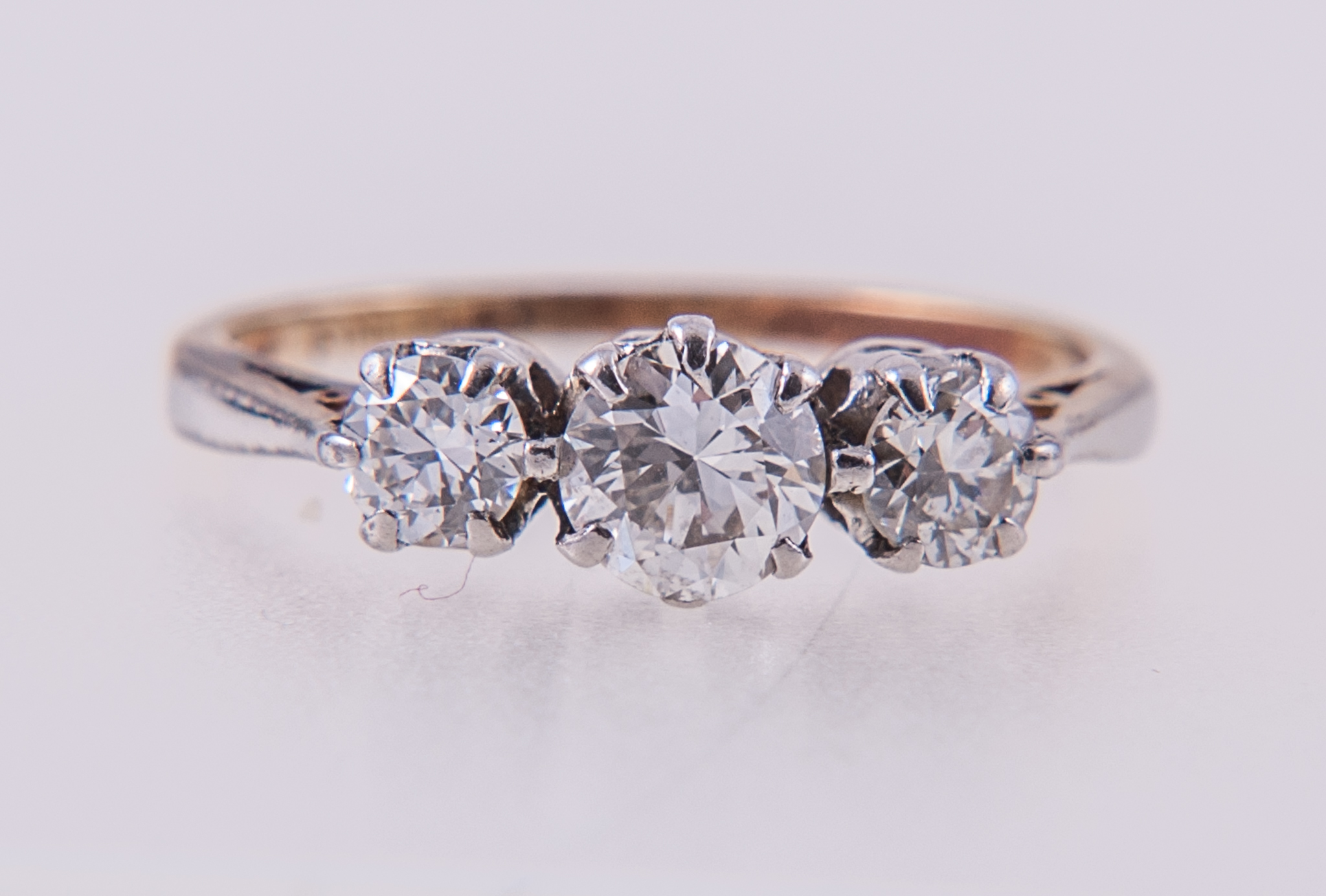 A diamond three stone ring, the brilliant cut stones, graduating in size,