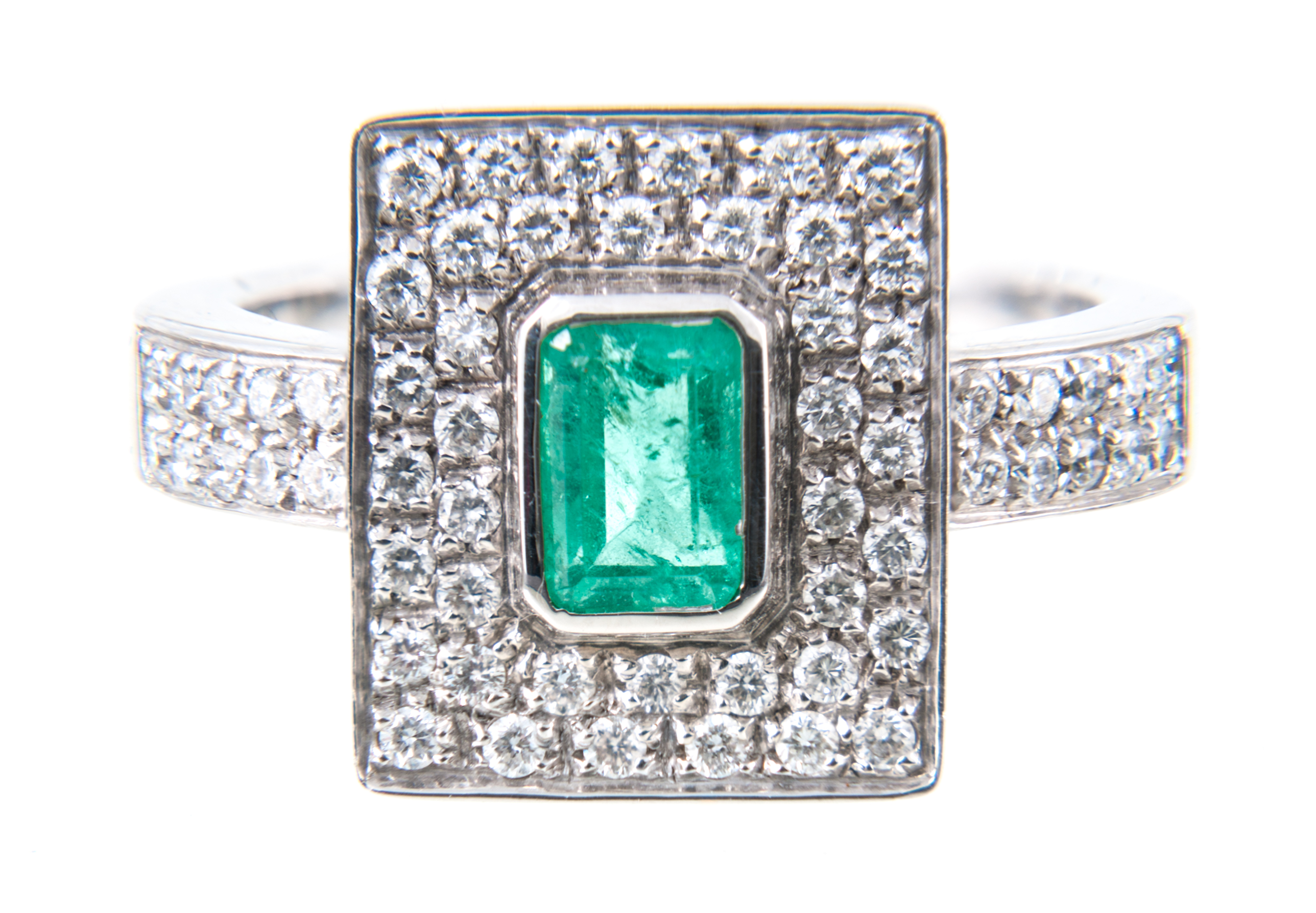 An emerald and diamond rectangular cluster ring, the rectangular step cut emerald 5.2mm x 3.