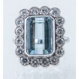 An aquamarine and diamond rectangular cluster ring, the step cut aquamarine 14mm x 10mm,