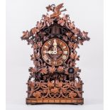 Black Forest style cuckoo clock, with grape and vine carved fenced gallery decoration,