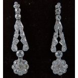 A pair of Art Deco design white metal and diamond drop earrings, with nine stone circular clusters,