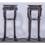 A pair of Chinese rosewood stands, octagonal tops with marble inset,