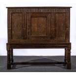 Oak dole cupboard, some 18th century elements, part hinged lid, front facia with fluting,