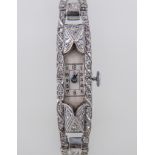 An Art Deco white metal and diamond encrusted cocktail watch,