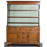 George III oak dresser, the panelled back with moulded cornice, three fixed shelves,