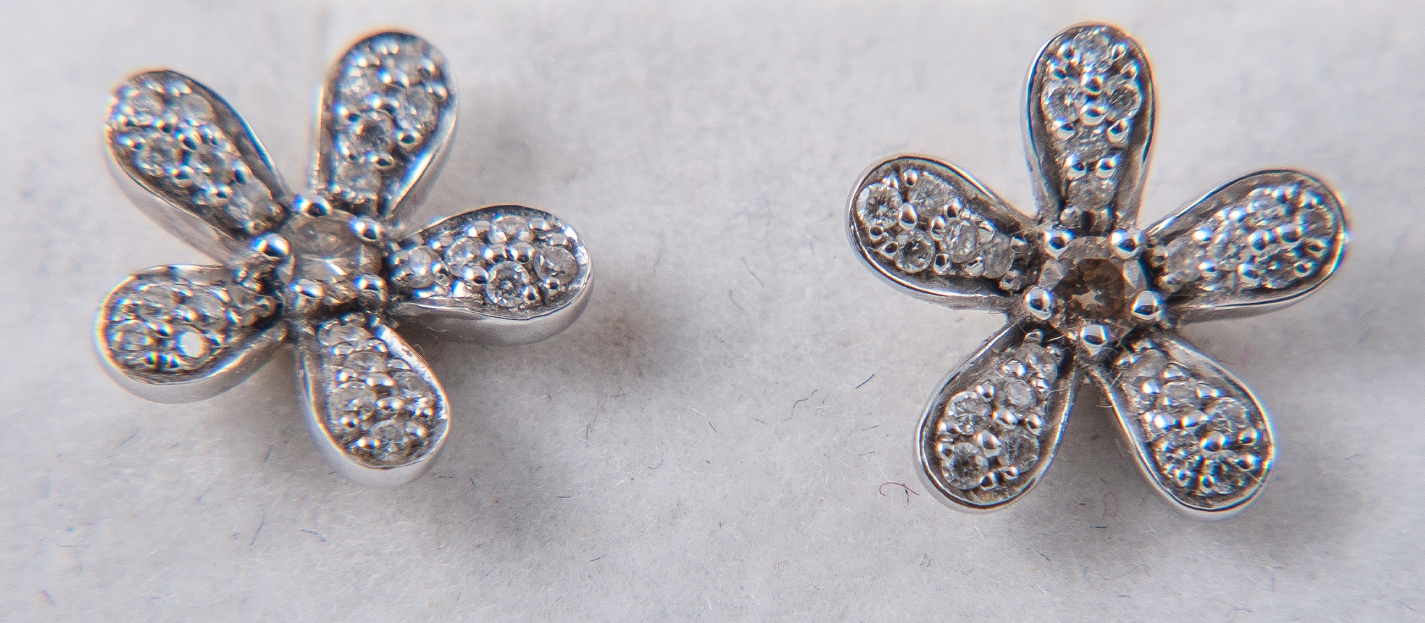 A pair of floral design diamond earrings,