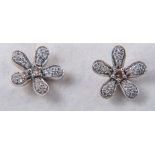 A pair of floral design diamond earrings,