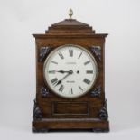 A William IV rosewood mantel clock, sarcophagus hood with gilt metal pineapple finial,