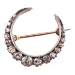 A diamond closed crescent brooch,