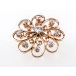 A circular diamond set brooch, the yellow metal frame 30mm diameter,