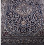 Nain Persian pattern carpet, central medallion on a blue ground floral field, border within guards,