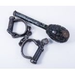 A pair of 1952 steel military handcuffs, and a WWI hand grenade, (2).