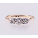 A diamond three stone ring, the brilliant cut stones,