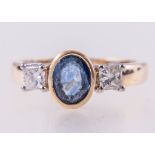 A sapphire and diamond ring, one sapphire, 7mm x 5mm oval mixed cut stone,