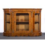 A Victorian walnut credenza, break front frieze, quandrant ends, three glazed doors,