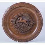 A carved oak circular plaque, Northamptonshire First Yeomanry, diameter 33cms,