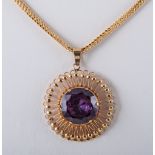 A purple stone set pendant and chain,