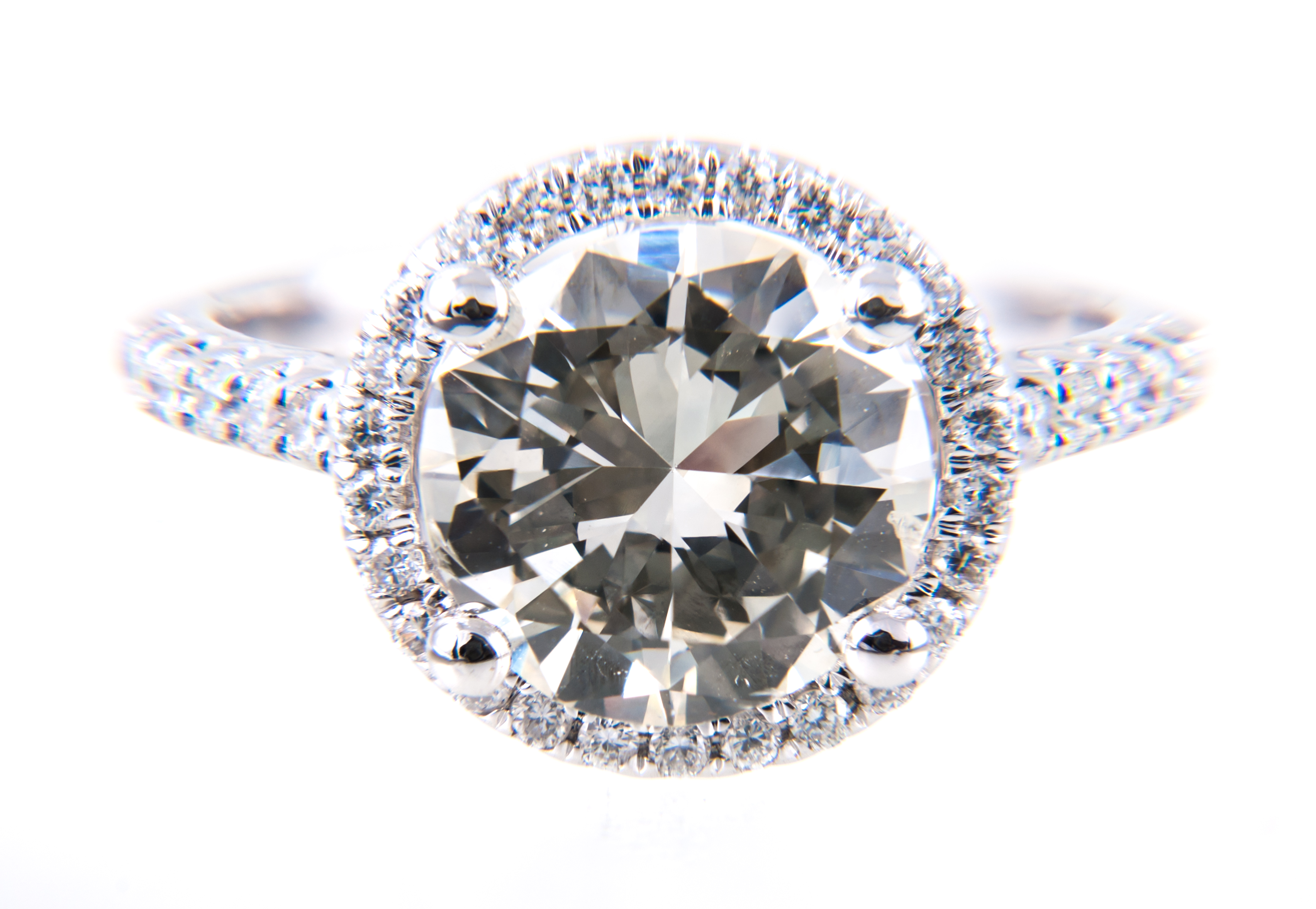 A diamond solitaire ring in a diamond "halo" setting,