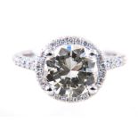 A diamond solitaire ring in a diamond "halo" setting,