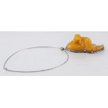 A Baltic amber pendant, carved in the form of a seal, 90cm x 35cm,