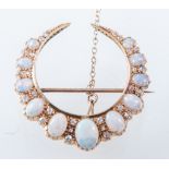 An opal and diamond closed crescent brooch,