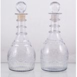 Pair of mallet shaped decanters, milled ring collars, swag and star cut bowls, with stoppers, 27cm.