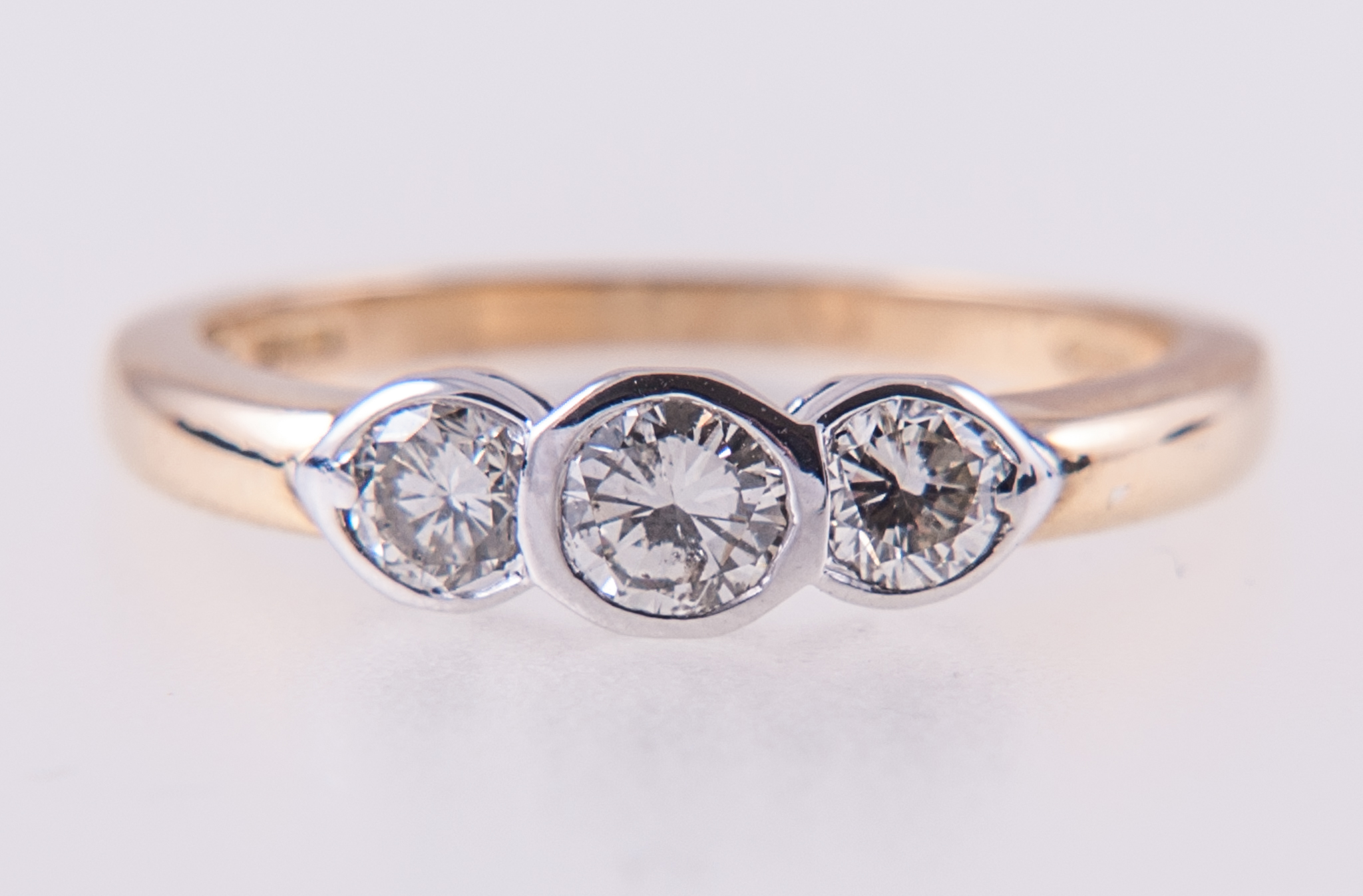 A diamond three stone ring, the brilliant cut stones, slightly graduating in size,