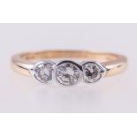 A diamond three stone ring, the brilliant cut stones, slightly graduating in size,