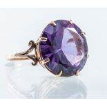 A purple stone dress ring,