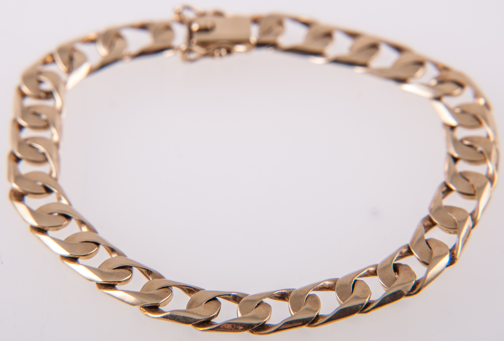 A hallmarked 18 carat yellow gold bracelet, 7.4mm wide flat square curb link chain, 19.