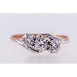 A diamond three stone crossover ring,