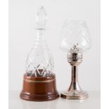 Crystal decanter, slice-cut decoration, in a turned mahogany silver-mounted stand,